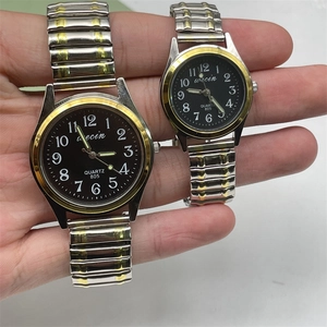 Close-up of elastic quartz watch with large numerals and luminous hands on black dial