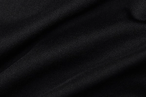 Close-up of premium black knit fabric texture showing fine weave and soft drape