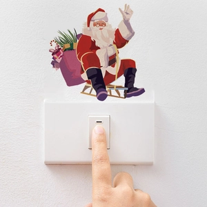 Macro view of watercolor Santa Claus wall sticker placed above a light switch