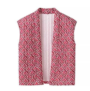 Detail view of red and white geometric pattern quilted cotton vest with a warm padded texture