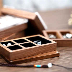 Close-up of black walnut jewelry box showing wood grain and soft black velvet lining