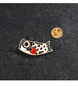 Detail of a Japanese koinobori carp enamel pin with gold alloy border and butterfly clutch