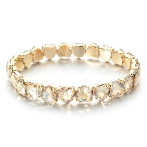 Detail of champagne heart-cut zircon stones with gold prong setting on the bracelet