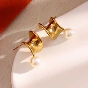 Detailed view of 18K gold plated spiral metal earrings featuring elegant white pearls
