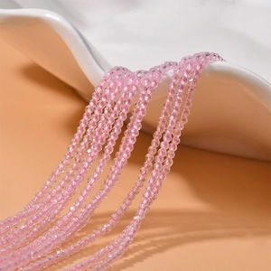 Macro shot of 2mm faceted pink crystal beads on a string for DIY jewelry making