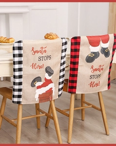 Detail of Christmas chair cover with Santa Stops Here print and plaid border decoration