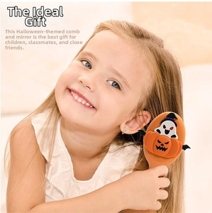 Little girl using a Halloween pumpkin ghost hairbrush with an orange cushion and 3D motifs