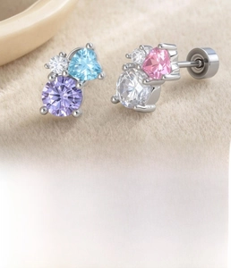 Macro detail of heart and round cubic zirconia stud earrings with steel screw backs