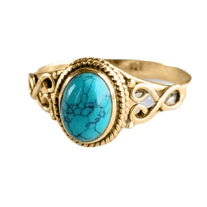 Detail of vintage turquoise ring featuring hollowed-out patterns and gold metal texture