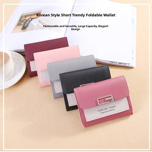 Short tri-fold wallets in pastel colors with metal buckles and pebbled leather texture