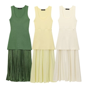 Detailed view showing the pleated texture and high-waist stitching of the knit dresses