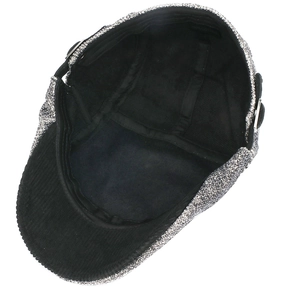 Detail view of cotton beret showing 100% cotton label and black corduroy brim lining