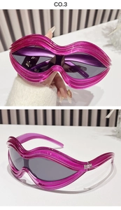 Detail of pink wave-shaped Y2K sunglasses with dark lenses and oversized frames