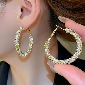 Elegant large gold hoop earrings with shimmering crystals for a luxury style