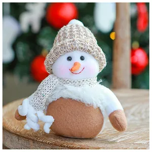 Detailed view of plush snowman doll with sequined scarf and knitted hat for Christmas décor