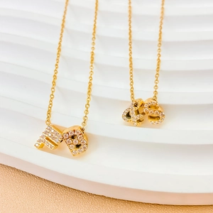 Macro detail of gold-plated hip hop pendant necklaces with shiny cubic zirconia stones