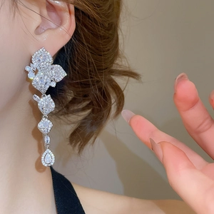 Detailed view of silver luxury leaf flower drop earrings with sparkling zircon tassels