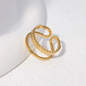 Detailed shot of gold double-layer leaf pattern ring on minimalist white background