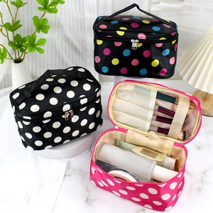 Set of polka dot cosmetic bags with zippers, handles and organized interior storage