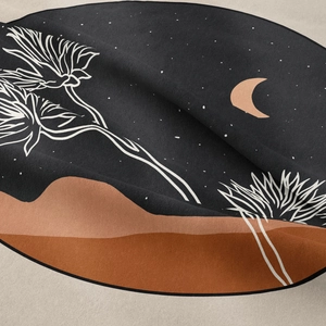 Close-up showing the soft fabric texture and artistic moon and stars print on the tapestry