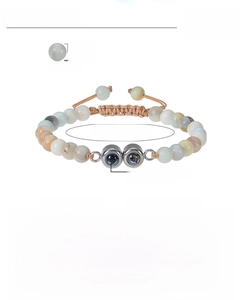 Macro shot of Amazonite beaded bracelet with 100 languages projection stone and brown cord