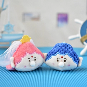 Primer plano detallado de lindos peluches de buda de loto rosa y azul con diseño de burbujas