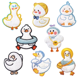 Set of eight cartoon duck embroidery patches for clothes and phone cases on white background