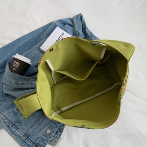 Grass green large canvas tote bag with magnetic snap and multi-pocket interior detail
