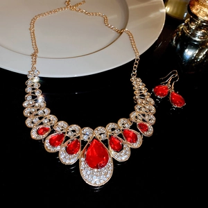 Vintage gold jewelry set with red teardrop gemstones and necklace and earrings