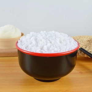 Realistic artificial white rice in black and red bowl used as a photography food prop