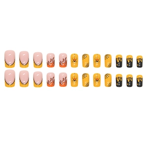 Halloween press-on nails with spider, flame, and scar designs in yellow and black