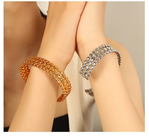 Close-up of three-layer beaded open bangles in gold and silver finish on wrist