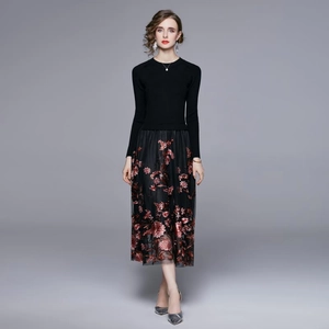 Elegant black knit dress with heavy floral embroidery and mesh paneling in full length