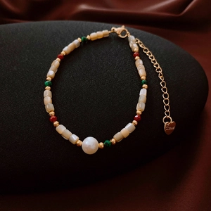 Detail of 18k gold plated stainless steel bracelet with freshwater pearls and beads