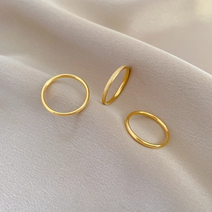 Three-piece gold minimalist ring set featuring matte and polished titanium steel bands