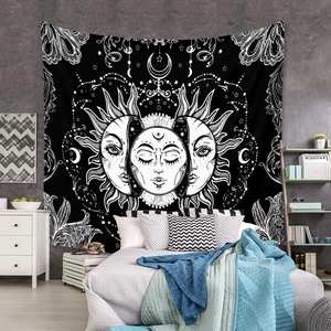 Detailed view of bohemian celestial tapestry with sun and moon over a cozy bed