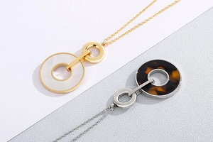 Detailed shot of gold and silver shell pendants with circular link chain necklace