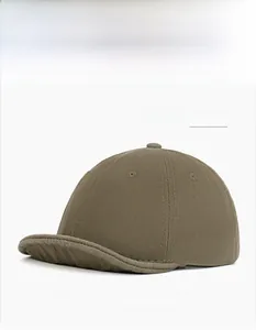 Detail of military green short brim baseball cap in vintage twill cotton fabric