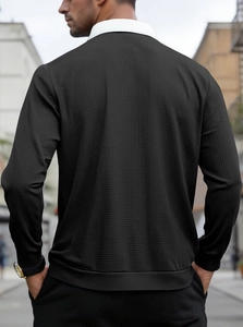 Street view of men's black waffle texture quarter-zip sweatshirt showing the back detail