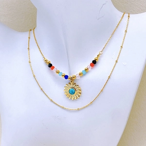 Bohemian double-layered gold necklace with colorful beads and turquoise sun pendant