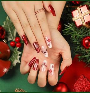 Detailed view of red glitter Christmas coffin press-on nails with snowflake and deer horn gems