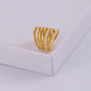 Elegant multi-layer gold plated ring with zircon stones on a white jewelry display