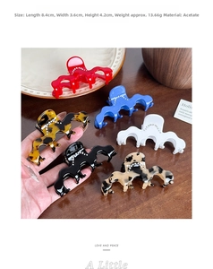 Detail showing wavy acetate hair claw clips in various colors with rhinestone accents