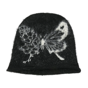 Women's oversized black knit beanie with a white butterfly pattern and mohair texture