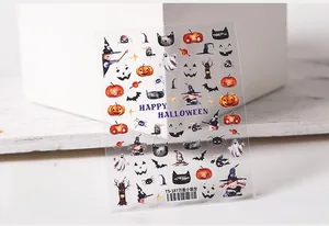Detail of Halloween nail stickers featuring watercolor pumpkins, ghosts, and black cats