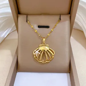 Elegant gold shell necklace with small starfish pendant displayed in a luxury jewelry box