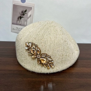 Beige knit beret for women featuring champagne rhinestone flowers and shimmering yarn details
