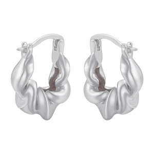 Macro detail of silver twisted metal hoop earrings showing the glossy texture and design