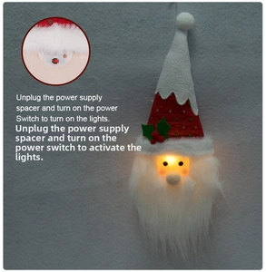Detail view showing the LED power switch and battery compartment of the Santa hanging ornament