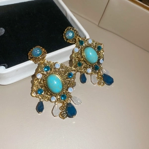Detailed close-up of vintage resin rhombus stud earring with turquoise center stone